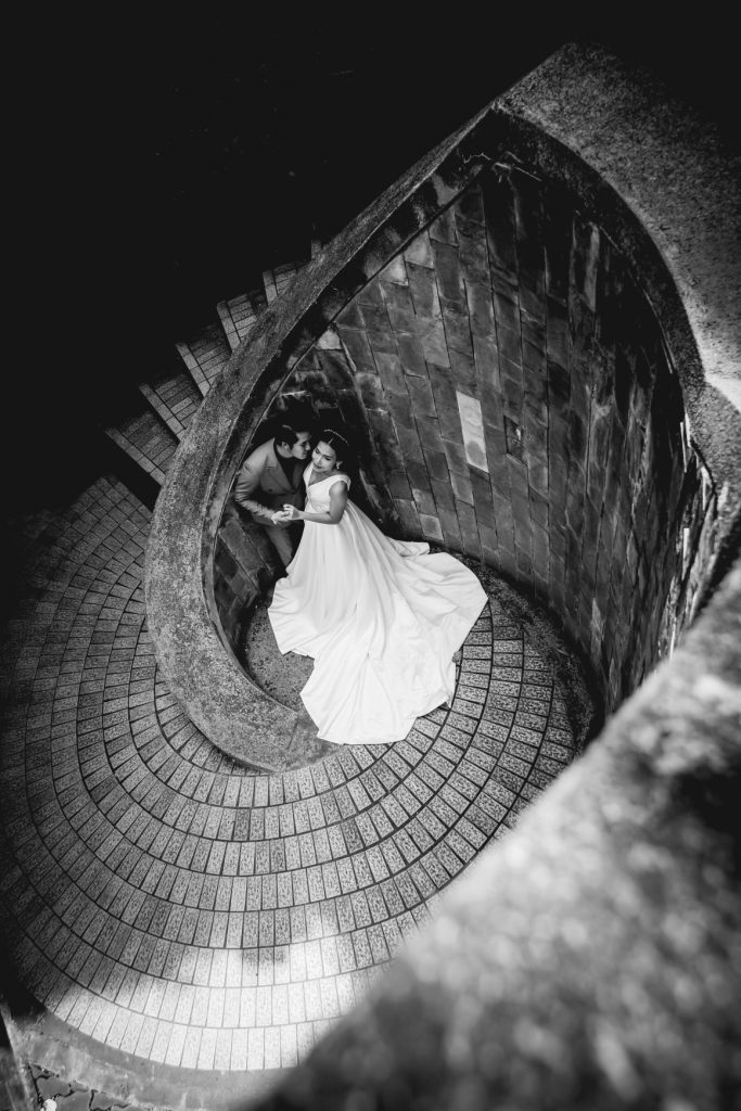 A couple standing at the bottom of the staircase for wedding photography